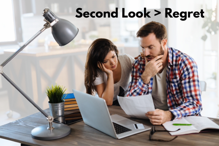 Couple reviewing mortgage documents at kitchen table in Raleigh, NC asking can you switch mortgage lenders before closing and considering a second look before signing.